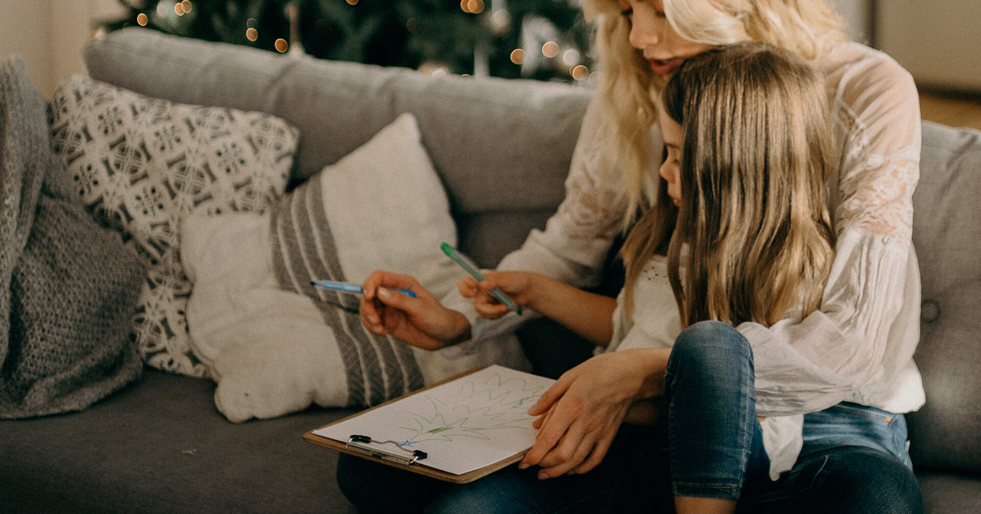 Woman and Girl Writing on Clipboard