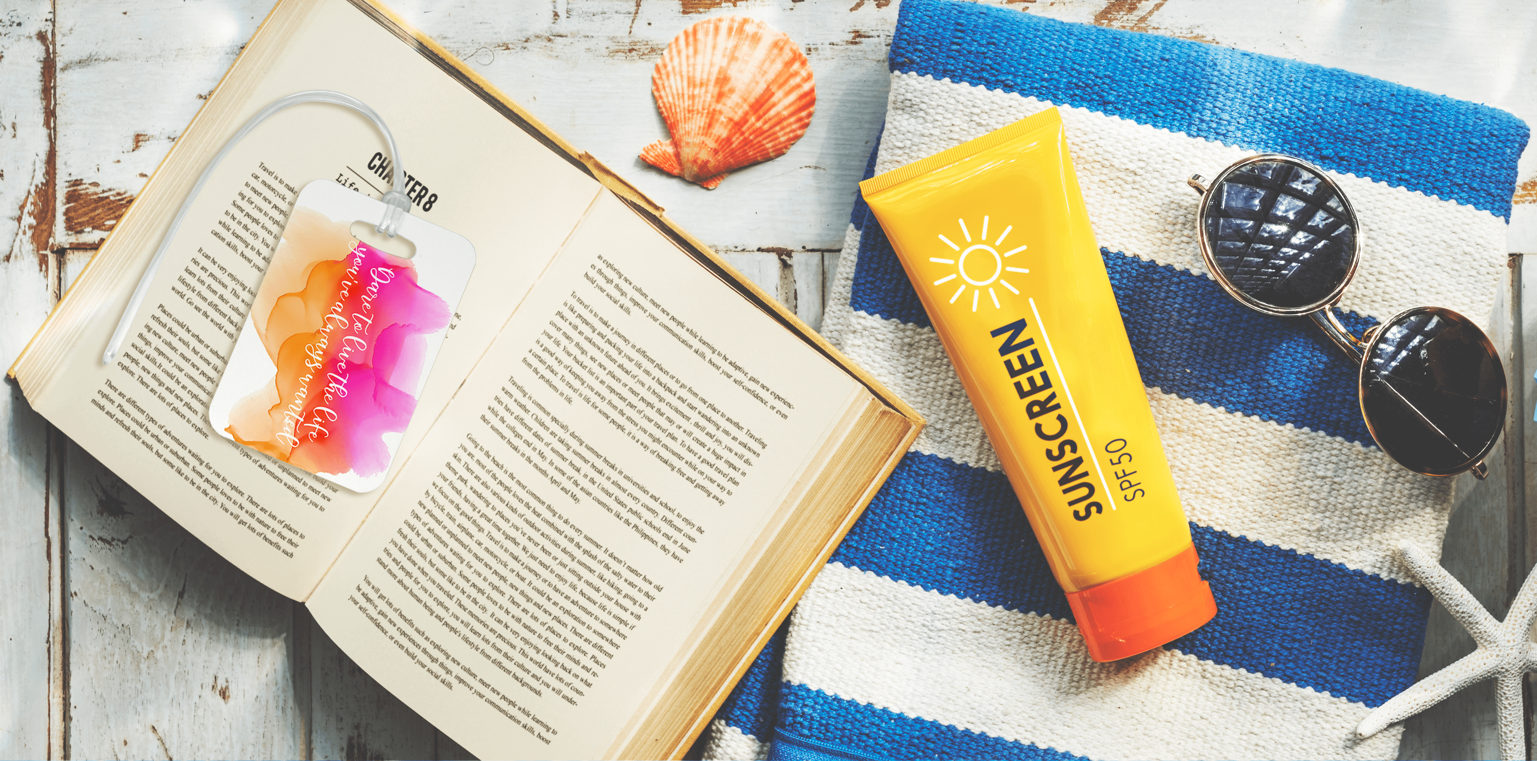 Book, Luggage Tag, Sunscreen, & Glasses on Towel
