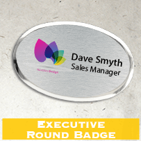 “Executive Round Badge” — silver oval/round badge with logo