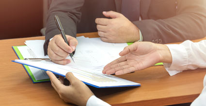 People Signing Documents